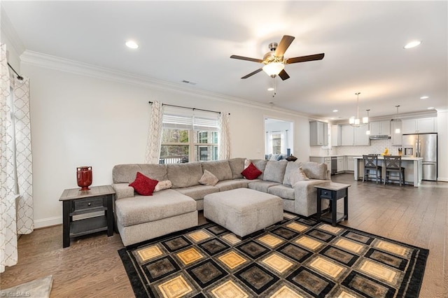 7722 NW Meadows Dr, Stokesdale, NC 27357 - living area with ornamental molding, dark wood-style flooring, a ceiling fan, and recessed lighting
