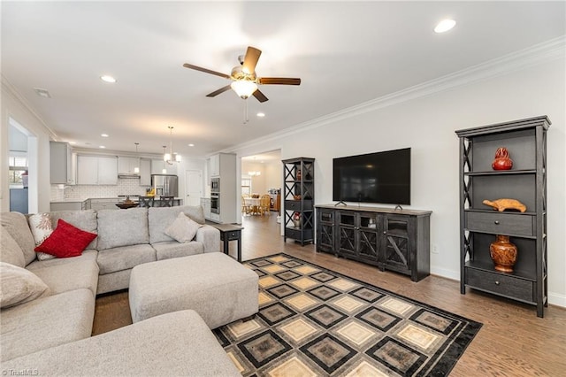 7722 NW Meadows Dr, Stokesdale, NC 27357 - living area with crown molding, ceiling fan, wood finished floors, and recessed lighting