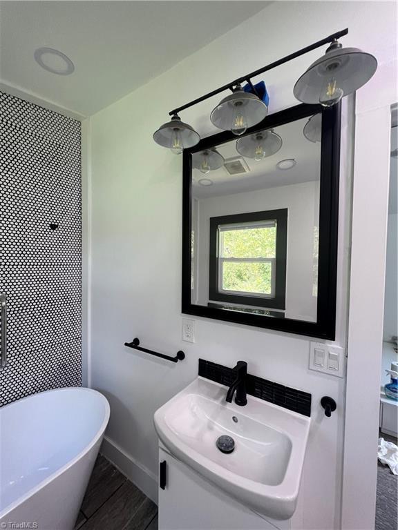 2042 Harrison Ave, Winston-Salem, NC 27105 - bathroom featuring vanity and wood finished floors