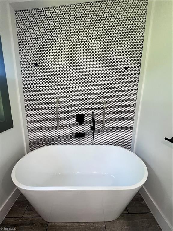 2042 Harrison Ave, Winston-Salem, NC 27105 - bathroom featuring baseboards and a freestanding tub