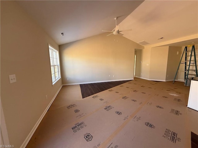 spare room featuring visible vents, baseboards, vaulted ceiling, and a ceiling fan