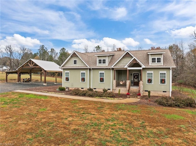 craftsman house featuring a front lawn, a porch, and a carport