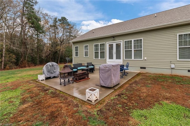 back of house with a lawn, a patio, and french doors