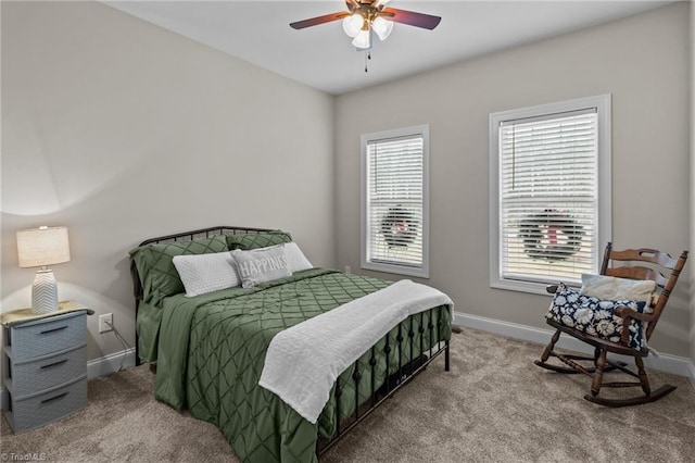 carpeted bedroom featuring multiple windows and ceiling fan