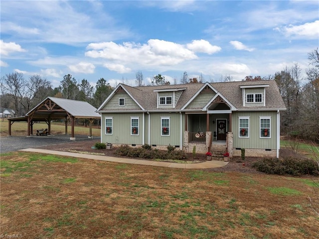 craftsman inspired home with a front yard, a porch, and a carport