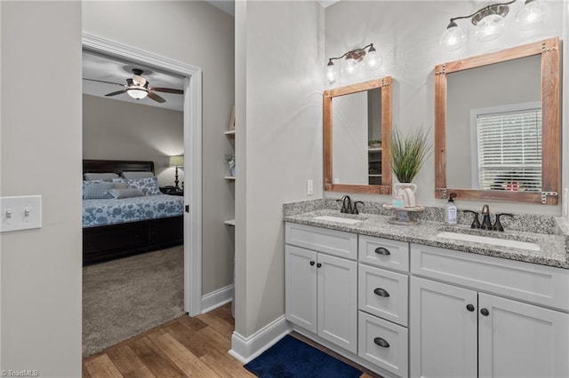 bathroom featuring vanity, hardwood / wood-style flooring, and ceiling fan