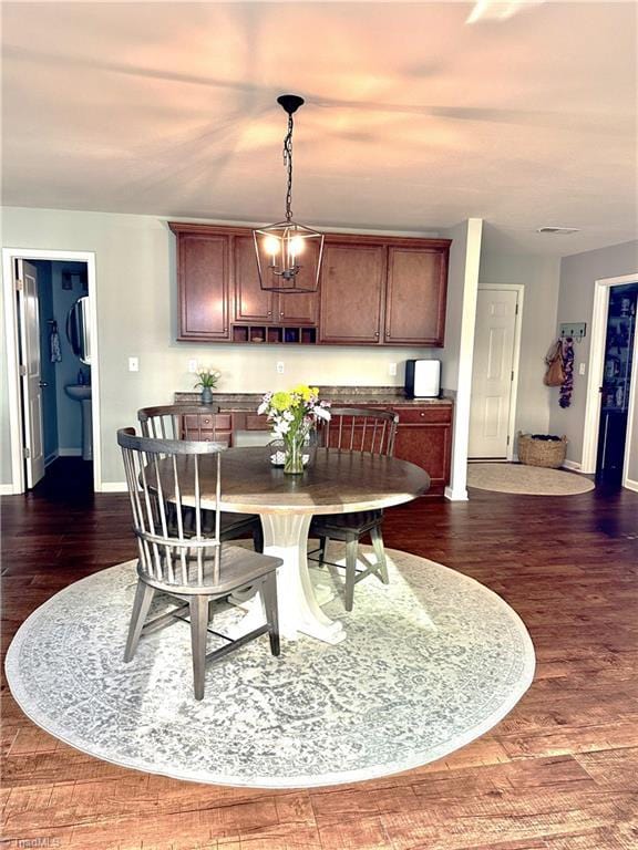 dining room with a chandelier and dark hardwood / wood-style floors