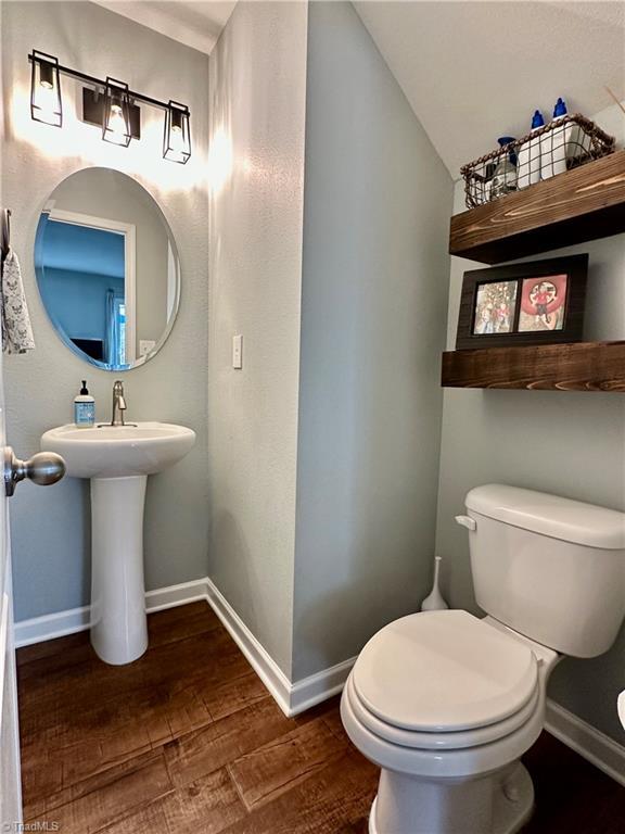 bathroom featuring sink, toilet, and hardwood / wood-style flooring