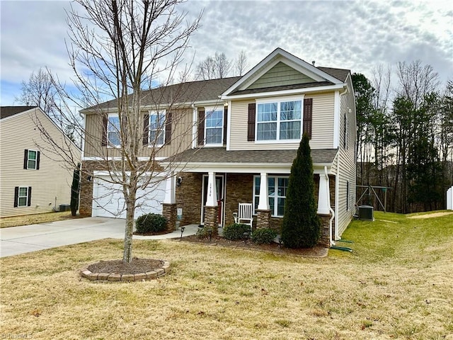 view of front of house featuring central AC, a front lawn, a porch, and a garage