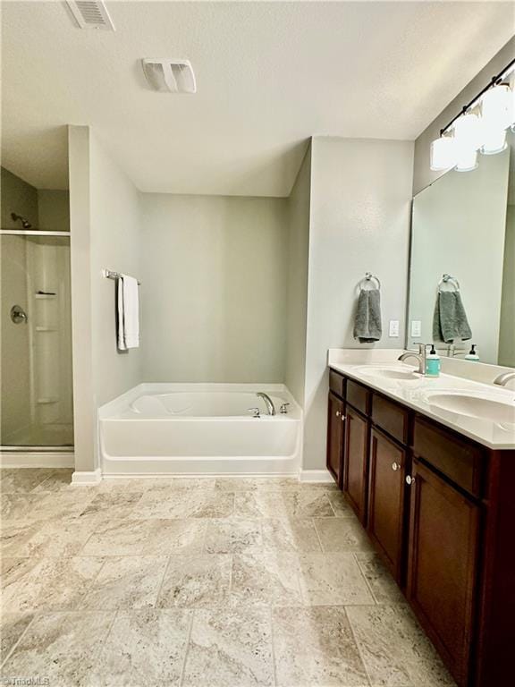 bathroom featuring plus walk in shower and vanity