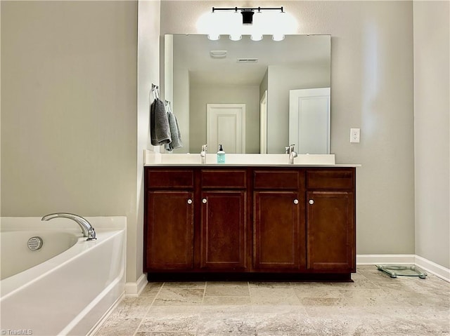 bathroom with a washtub and vanity