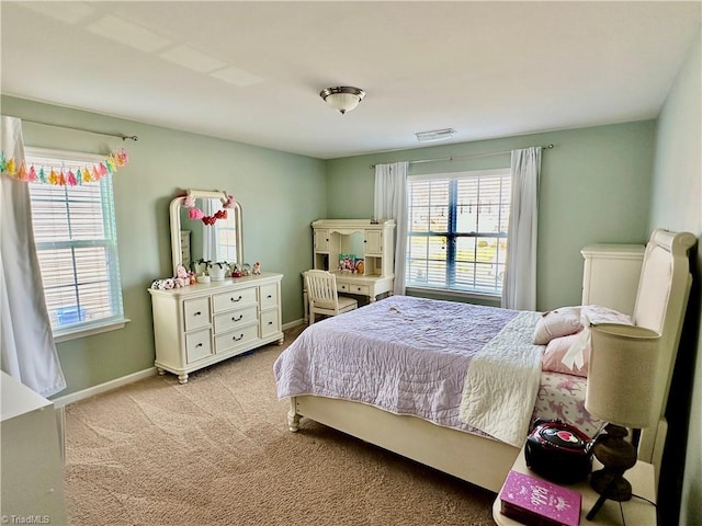 bedroom featuring multiple windows and light colored carpet