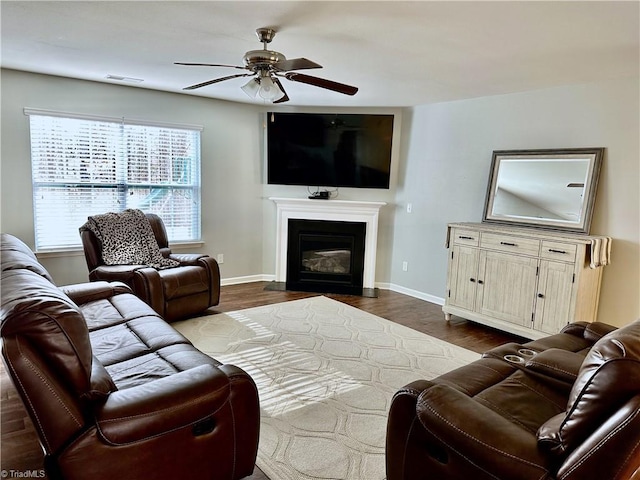 living room featuring ceiling fan and wood-type flooring