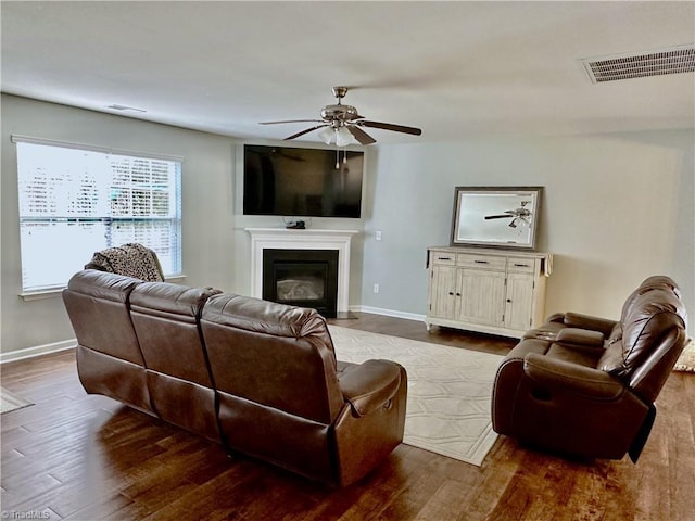 living room with hardwood / wood-style floors and ceiling fan