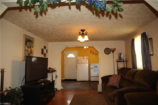 84 Sol Nunnally Rd, Pelham, NC 27311 - living room with wood finished floors, arched walkways, and a textured ceiling