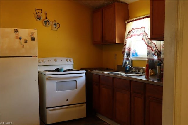 84 Sol Nunnally Rd, Pelham, NC 27311 - kitchen with white appliances, a sink, and brown cabinets