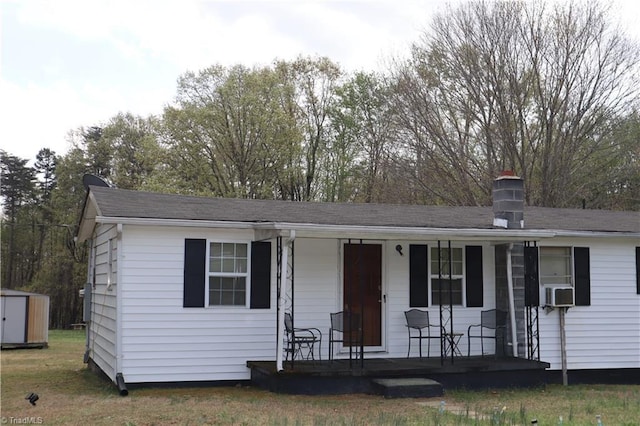 84 Sol Nunnally Rd, Pelham, NC 27311 - single story home with covered porch, a chimney, a storage shed, and an outbuilding
