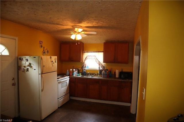 84 Sol Nunnally Rd, Pelham, NC 27311 - kitchen featuring white appliances, brown cabinets, healthy amount of natural light, a sink, and a textured ceiling