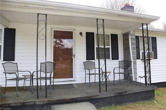 84 Sol Nunnally Rd, Pelham, NC 27311 - doorway to property with covered porch, a chimney, and cooling unit