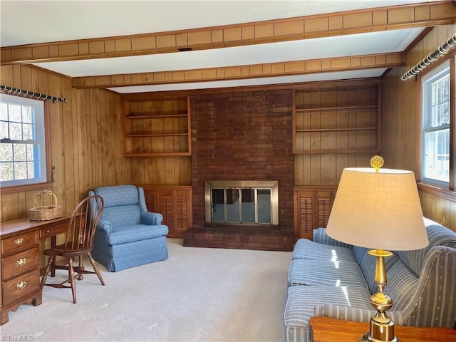 living room with built in features, wood walls, a fireplace, and carpet flooring