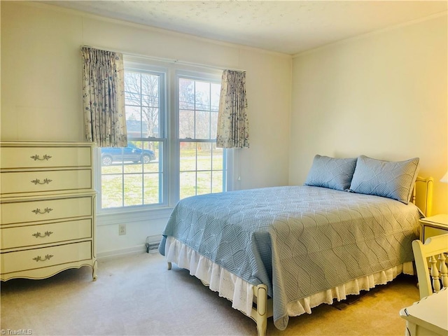 carpeted bedroom with multiple windows and baseboards