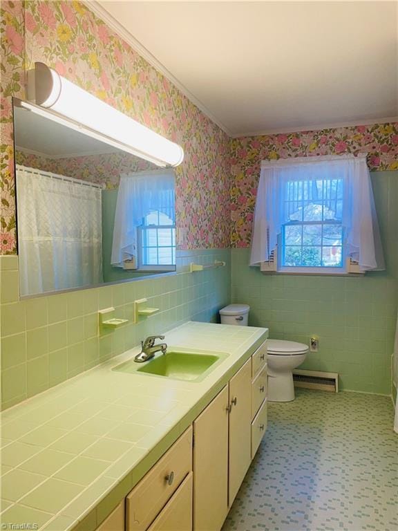 bathroom with wallpapered walls, a wainscoted wall, toilet, and visible vents