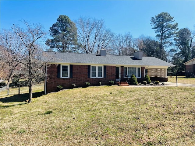 ranch-style house with brick siding, a chimney, a front lawn, and fence