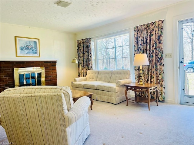 carpeted living area with visible vents, a textured ceiling, and a fireplace