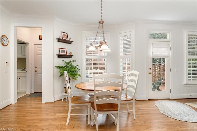 dining room featuring ornamental molding and light wood-type flooring