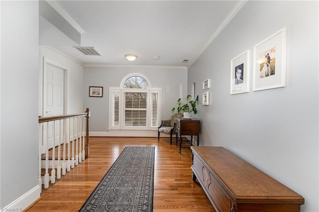 corridor with crown molding and light hardwood / wood-style floors