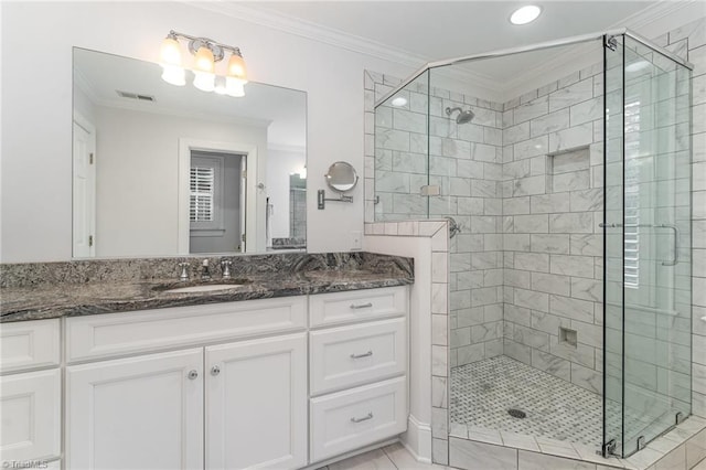 bathroom with ornamental molding, a shower with shower door, tile patterned flooring, and vanity