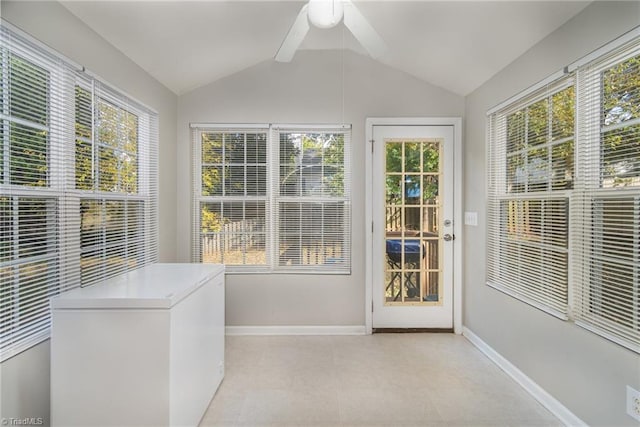 unfurnished sunroom with lofted ceiling and ceiling fan