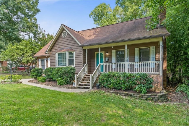 ranch-style home with brick siding, a chimney, a porch, and a front yard