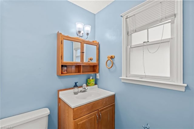 bathroom featuring toilet and vanity