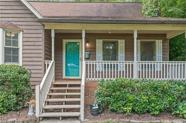 view of exterior entry with a porch