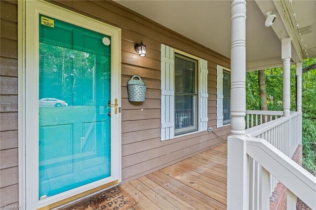 view of exterior entry with covered porch