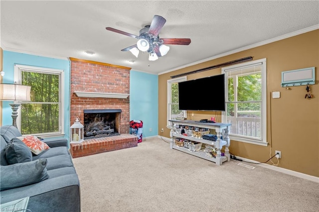 carpeted living room featuring a fireplace, ornamental molding, ceiling fan, and a textured ceiling