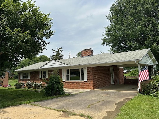 5912 US Highway 21, Jonesville, NC 28642 - ranch-style house with brick siding, driveway, a chimney, a carport, and a front yard