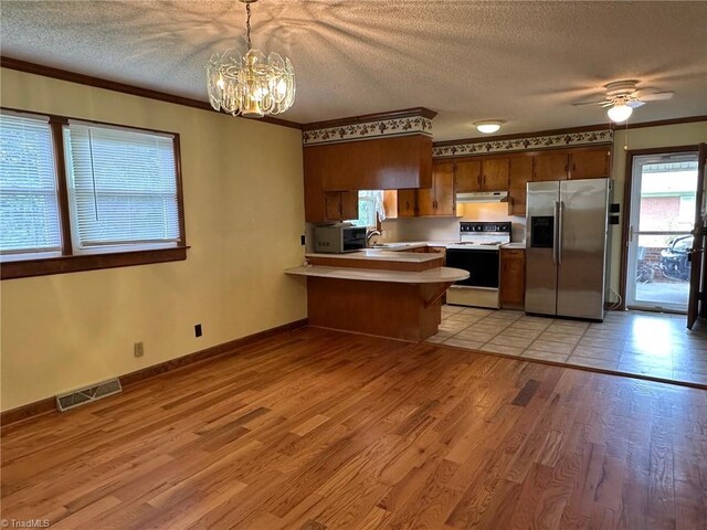 5912 US Highway 21, Jonesville, NC 28642 - kitchen featuring electric stove, stainless steel fridge, light countertops, a peninsula, and a textured ceiling