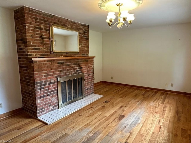 5912 US Highway 21, Jonesville, NC 28642 - unfurnished living room featuring a chandelier, wood finished floors, and baseboards