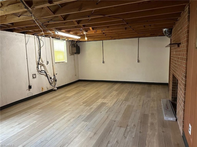 5912 US Highway 21, Jonesville, NC 28642 - below grade area with light wood finished floors, baseboards, a fireplace, and electric panel