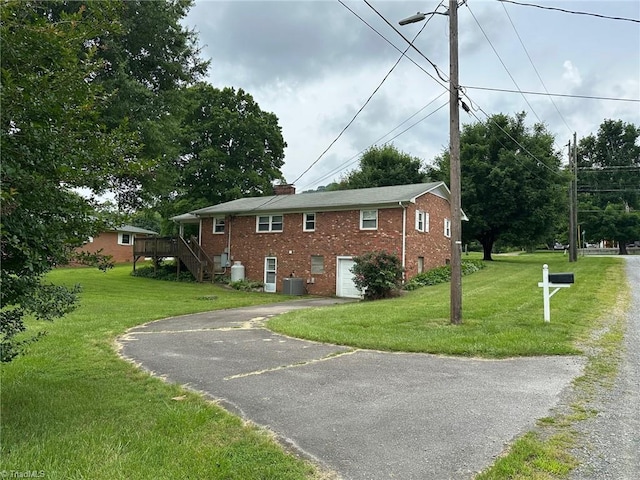 5912 US Highway 21, Jonesville, NC 28642 - view of home's exterior with asphalt driveway, brick siding, central air condition unit, stairway, and an attached garage