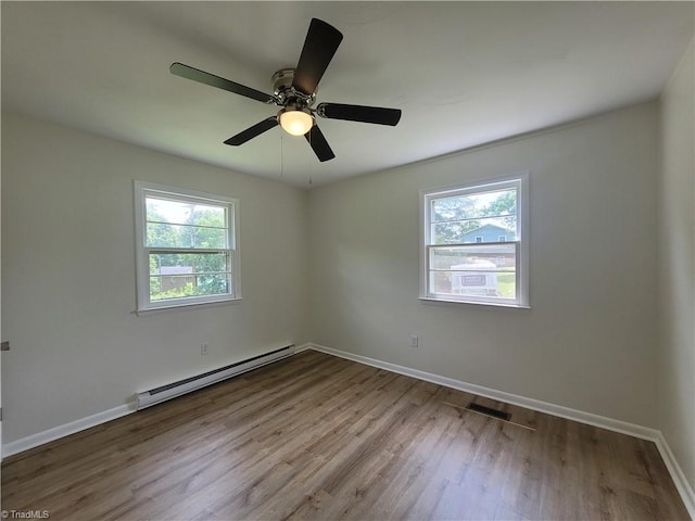 133 Lori Ln, Mount Airy, NC 27030 - unfurnished room featuring a baseboard radiator, plenty of natural light, wood finished floors, and a ceiling fan