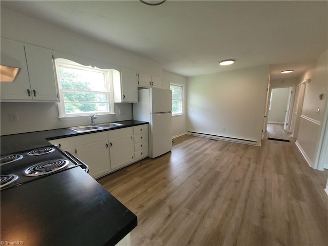 133 Lori Ln, Mount Airy, NC 27030 - kitchen with a baseboard radiator, freestanding refrigerator, dark countertops, and white cabinetry