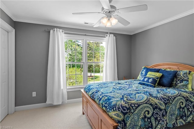 bedroom with multiple windows, light colored carpet, baseboards, ornamental molding, and a ceiling fan