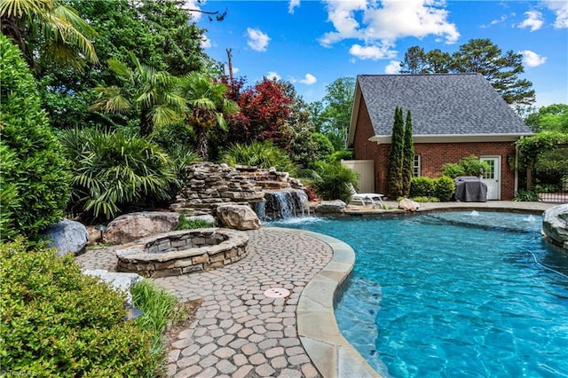 swimming pool with an outdoor fire pit and a patio area