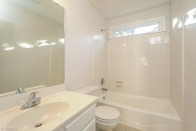 full bathroom featuring vanity, tiled shower / bath combo, and toilet