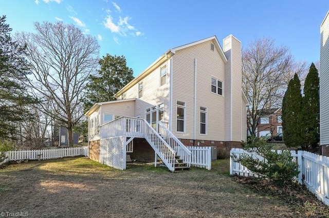 back of property featuring a wooden deck and cooling unit