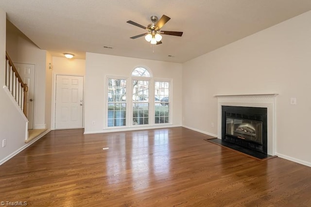 unfurnished living room with ceiling fan and dark hardwood / wood-style floors