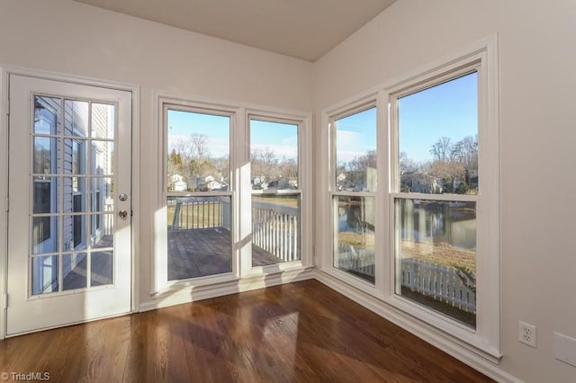 entryway featuring dark hardwood / wood-style floors and a water view